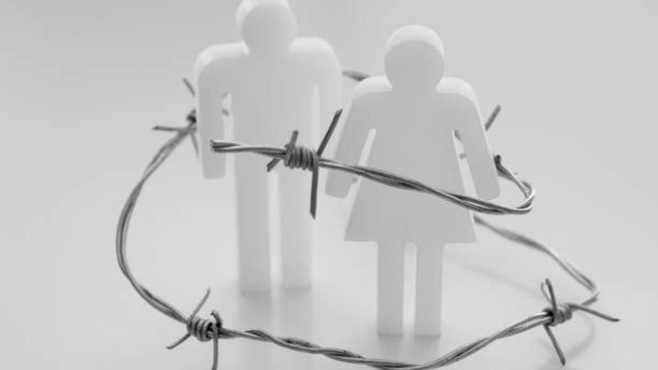 two figures with barb wire around them