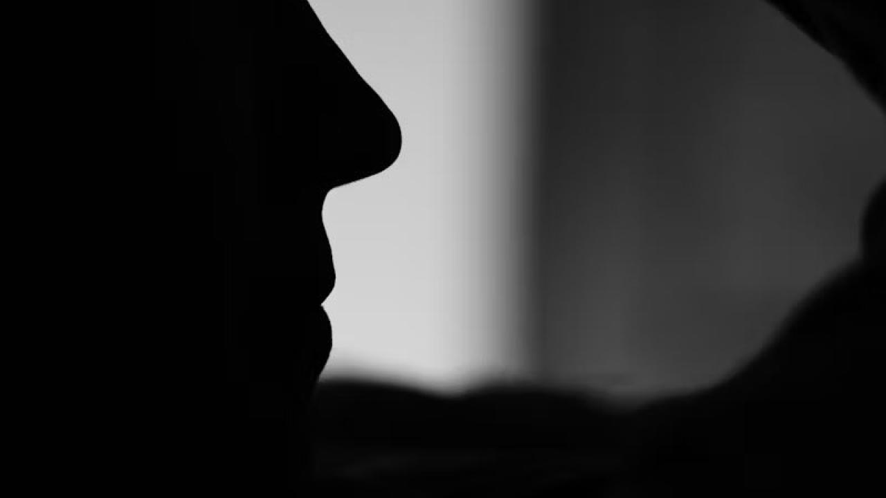 woman holding head in hands