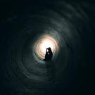 person alone in a tunnel
