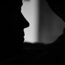 woman holding head in hands